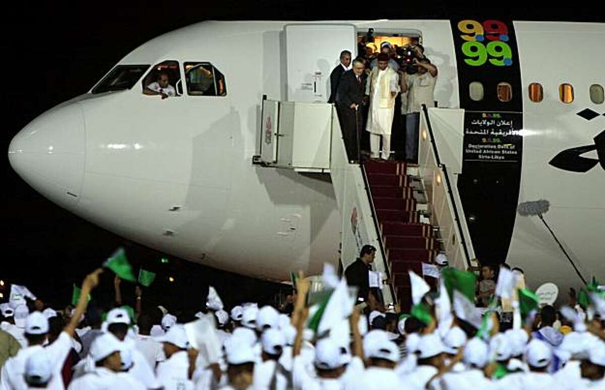 FILE - In this Aug. 20, 2009 file photo, hundreds of Libyans welcome Libyan Abdel Baset al-Megrahi, who found guilty of the 1988 Lockerbie bombing, top left, as he is accompanied by Seif al-Islam el- Gadhafi, son of Libyan leader Libyan leader Moammar Gadhafi upon his arrival at airport in Tripoli, Libya, Thursday, Aug. 20, 2009 after Scotland freed the terminally ill Lockerbie bomber on compassionate grounds Thursday, allowing him to die at home in Libya. A year after Scotland's release of the terminally ill Lockerbie bomber from prison caused an uproar, Abdel Baset al-Megrahi is still stirring outrage simply by surviving.