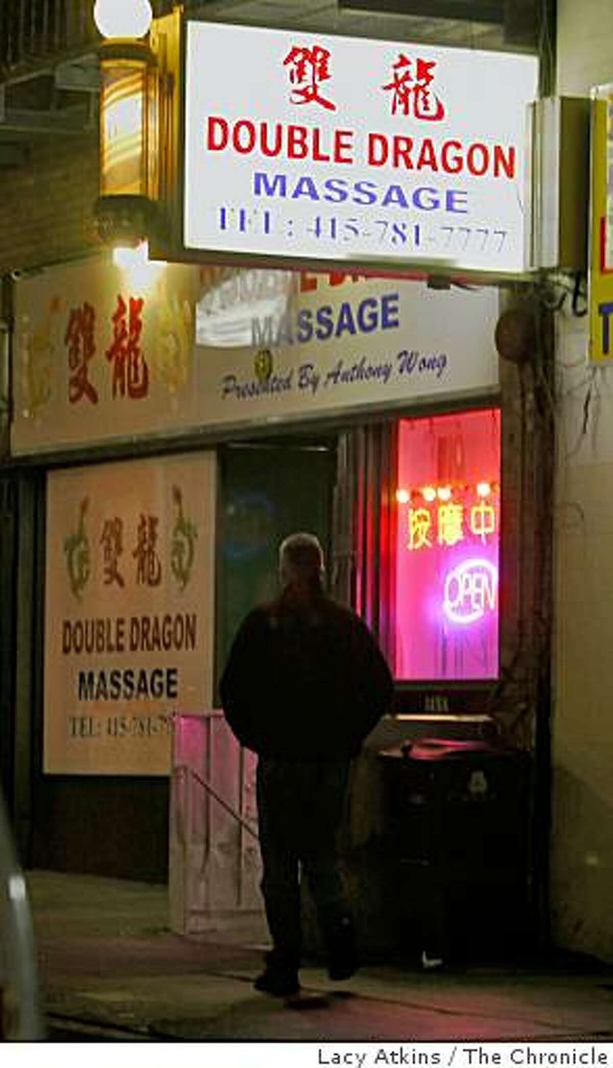 Under cover police offices first enter the Double Dragon Massage Parlor before the inspectors with the San Francisco Health Department enter on their surprise visits, Tuesday Nov. 25, 2008, in San Francisco, Calif. For the last two years the city of San Francisco has said it wants to crack down on brothels that front as massage parlors and parlors that have repeat health code violations. Yet city codes make it hard for the city to revoke illegal operators' licenses and the health department does not have enough staff to investigate the violations.