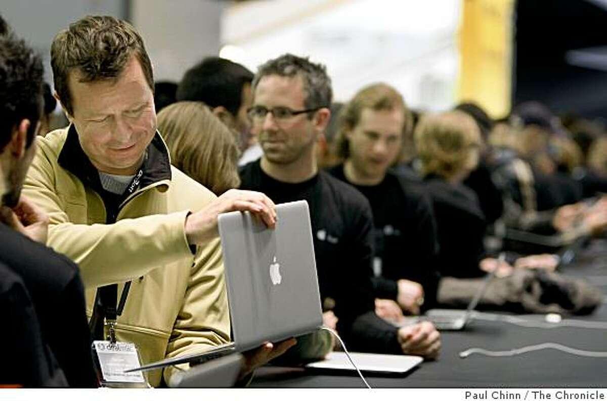 John Sills, left, inspects a MacBook Air on a demonstration table at the Macworld Expo in San Francisco, Calif. on Tuesday, Jan. 15, 2008. In his keynote speech, Apple CEO Steve Jobs introduced the new MacBook Air and Time Capsule as well as upgrades to the iPhone and iTouch.
