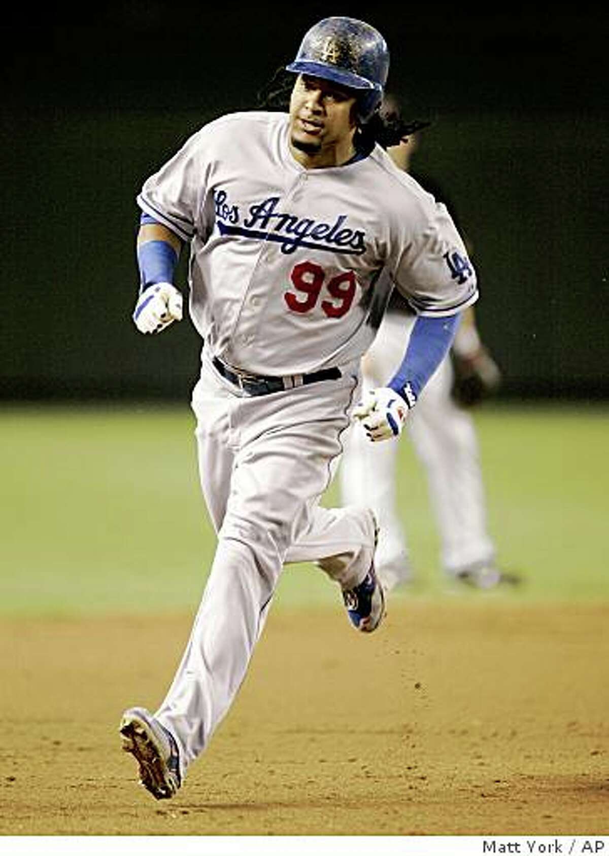 Los Angeles Dodgers' Manny Ramirez approaches third base after hitting a solo home run against the Arizona Diamondbacks during the third inning of a baseball game Saturday, Aug. 30, 2008, in Phoenix. (AP Photo/Matt York)