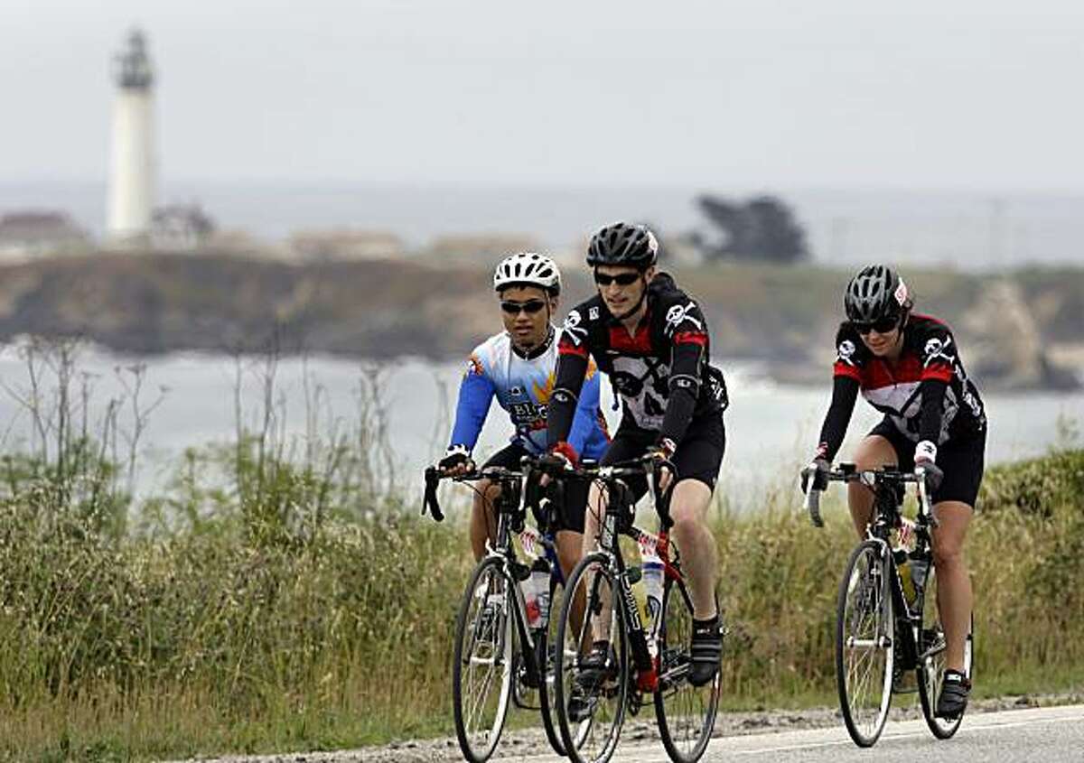 Bicyclists doing the AIDS/Lifecycle ride pass the lighthouse along Highway 1 as they make their way to Santa Cruz in 2009.