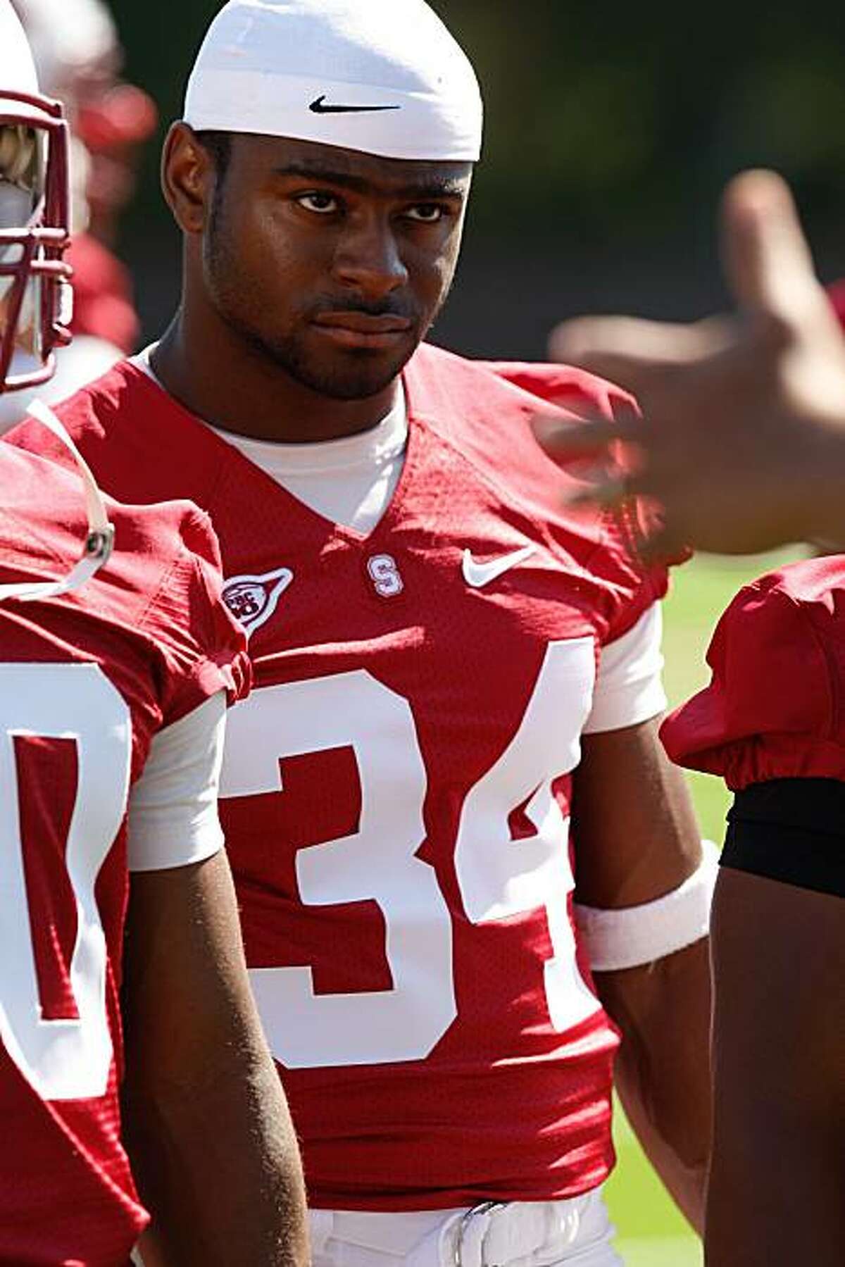 Cardinal Running Back Jeremy Stewart listens to a Stanford Coach during the Cardinal football training camp on Monday, August 9, 2010 in Palo Alto, Calif.