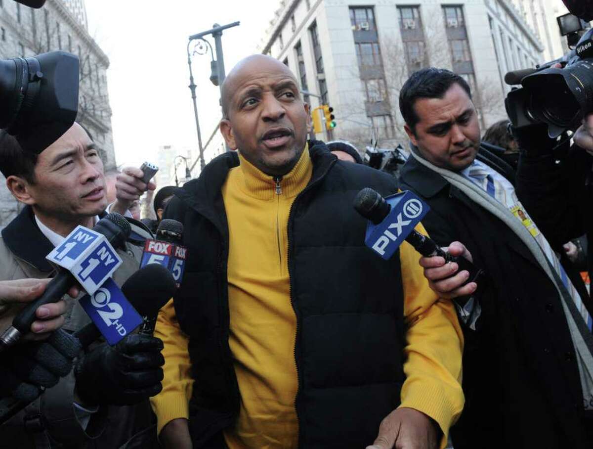 Carl Tyson, center, whose daughter Carlina White was kidnapped as a newborn from Harlem Hospital in August 1987, exits Manhattan Federal court, Friday, Feb. 10, 2012, in New York. A prosecutor in a case against Raleigh, North Carolina, resident Ann Pettway, the woman accused of snatching the newborn, says she will plead guilty Friday to criminal charges. (AP Photo/ Louis Lanzano)