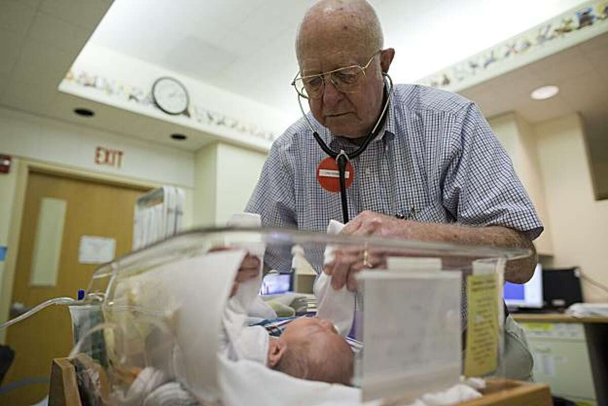 Dr Phillip Sunshine, 80 a neonatologist at Stanford's Children's Hospital looks over Nicholas Sims, born July 1, 2010, at the Lucile Packard Children's Hospital at Stanford, August 4, 2010 in Palo Alto, California. Photograph by David Paul Morris/Special to the Chronicle