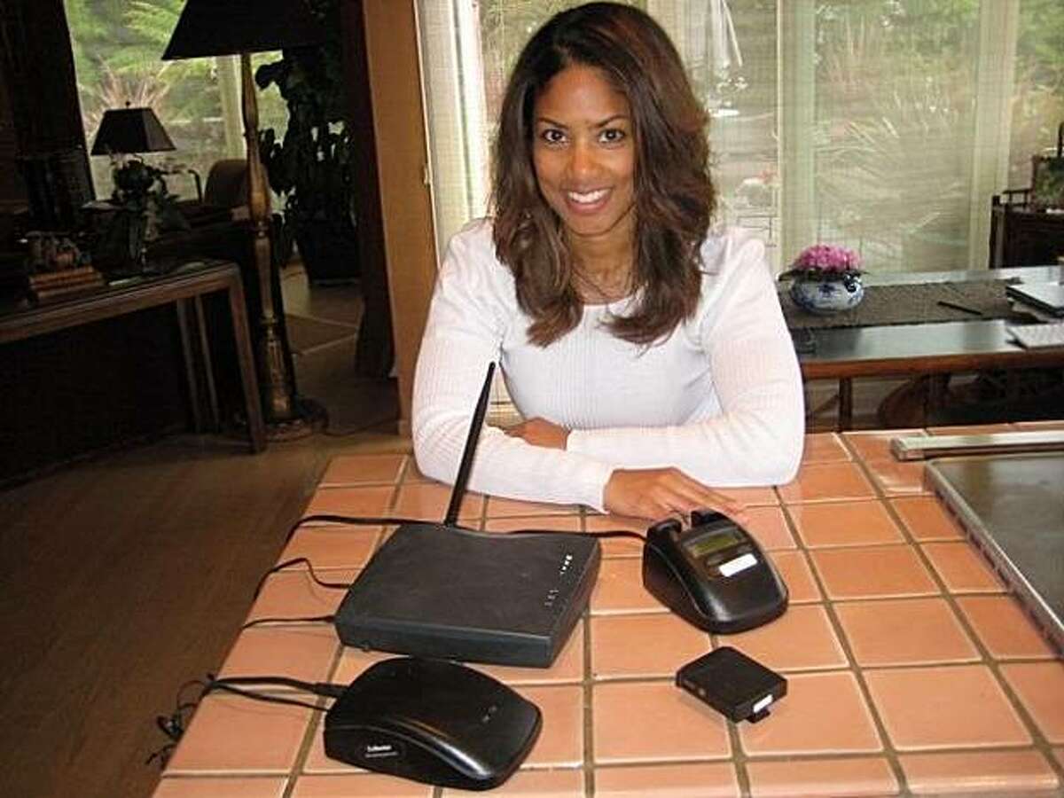 Angella Sprauve, with the arbitron "portable People mover" devices she used to have her radio listening habits tracked.