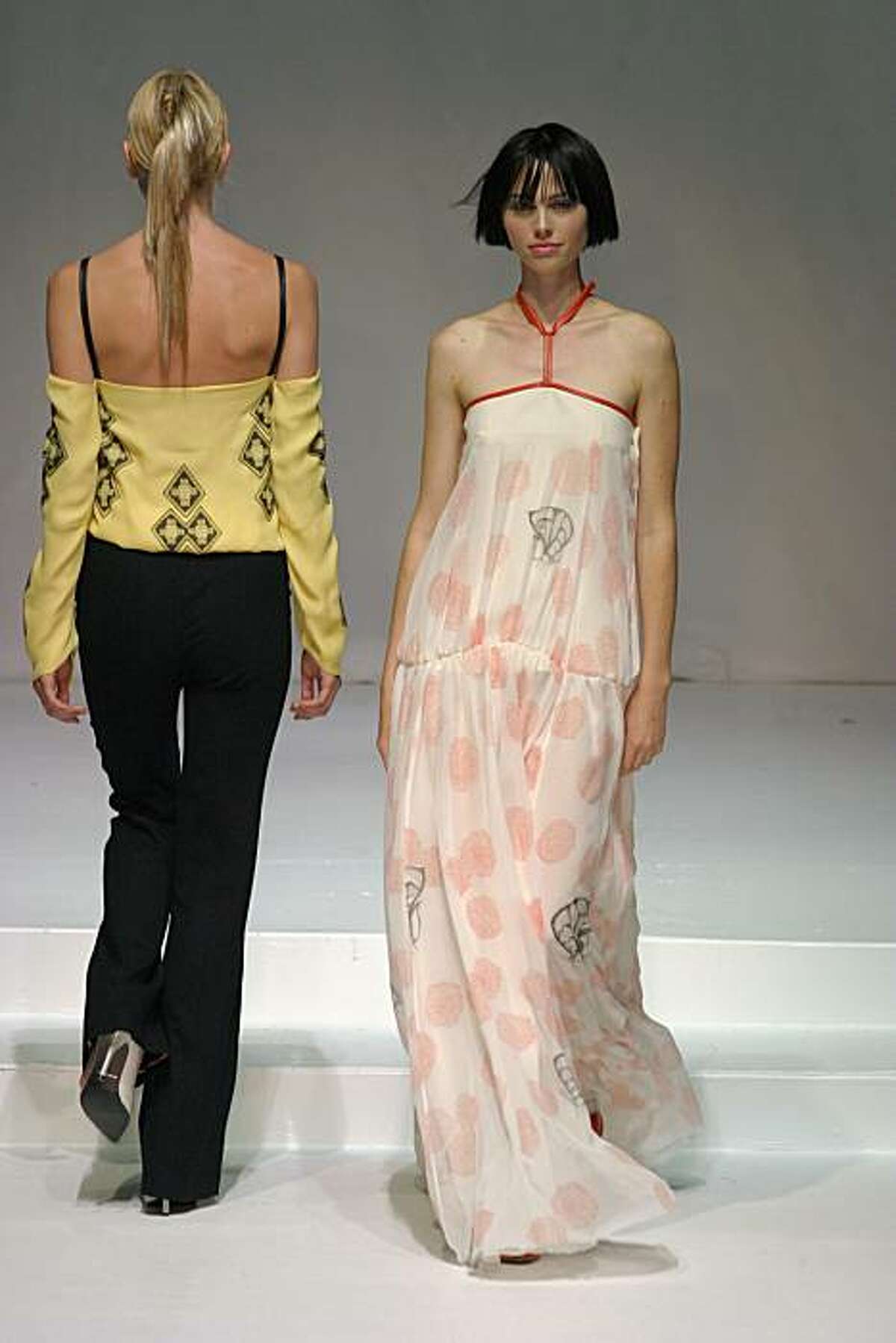 Women's wear designer Norman Ambrose, whose works are sold at Saks, Neiman Marcus and other upscale retailers, is a 2003 graduate of the Academy of Art University in San Francisco. Shown are models wearing his garments in the student showcase in 2003, filmier and looser than his now-tailored, elegant and city chic clothing.