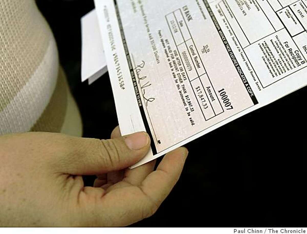 Francisca Amaral reviews a settlement check she received at her home in San Leandro, Calif., on Thursday, Dec. 18, 2008. Amaral was a lead plaintiff of a group of employees that successfully sued Cintas for back wages after the company was found to have violated a living wage law.