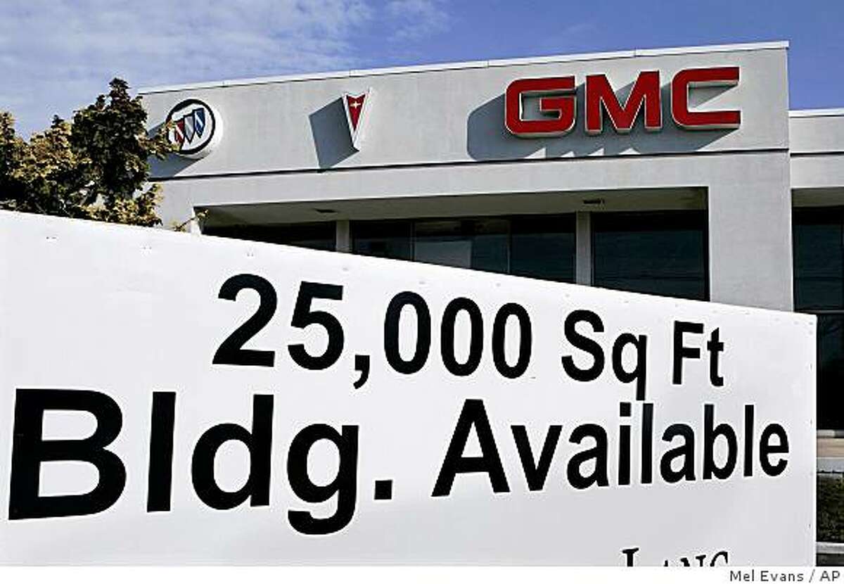 A real estate availability sign is seen in front of a closed auto dealership in East Brunswick, N.J., Sunday Dec. 14, 2008. The Bush administration is considering ways of providing emergency aid to General Motors Corp. and Chrysler LLC, which have said they could run out of cash within weeks without help from the government. (AP Photo/Mel Evans)