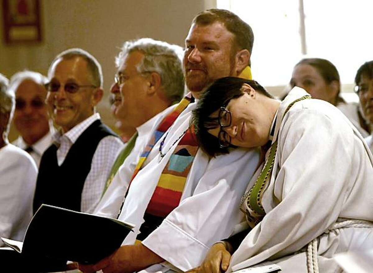 Pastor Megan Rohrer, right cuddle up to Pastor Craig Minich, center, as the service starts, July 25, 2010, at the St. Mark's Lutheran Church, in San Francisco, Calif. They are two of the seven lesbian, gay, bisexual and transgender Lutheran ministers, thaPastor Megan Rohrer, right cuddle up to Pastor Craig Minich, center, as the service starts, July 25, 2010, at the St. Mark's Lutheran Church, in San Francisco, Calif. They are two of the seven lesbian, gay, bisexual and transgender Lutheran ministers, that were officially welcomed to serve in the largest Lutheran denomination in the United States, the Evangelical Lutheran Church in America.