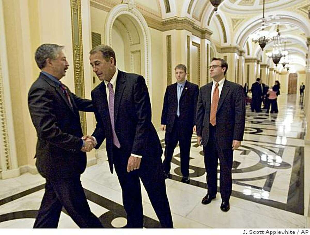The House Republican leader, Rep. John A. Boehner, R-Ohio, second from left, gets a word of consolation from Rep. John Salazar, D-Colo., left, after the auto industry bailout vote passed in the face of strong GOP opposition, at the Capitol in Washington, Wednesday, Dec. 10, 2008. Boehner said the legislation "asks taxpayers to further subsidize a business model that is failing to meet the needs of American workers and consumers." (AP Photo/J. Scott Applewhite)