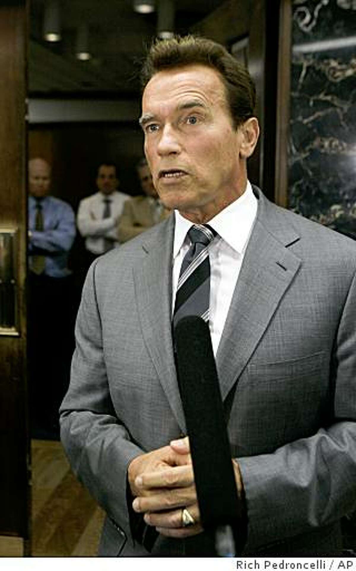Gov. Arnold Schwarzenegger talks with reporters about the Legislature's failure to reach a solution to the state budget deficit, outside his Capitol office in Sacramento, Calif., Tuesday, Nov. 25, 2008. The Legislature failed to approve a Democratic budget package which included $8.1 billion in budget cuts and $8.1 billion in new revenues.(AP Photo/Rich Pedroncelli)
