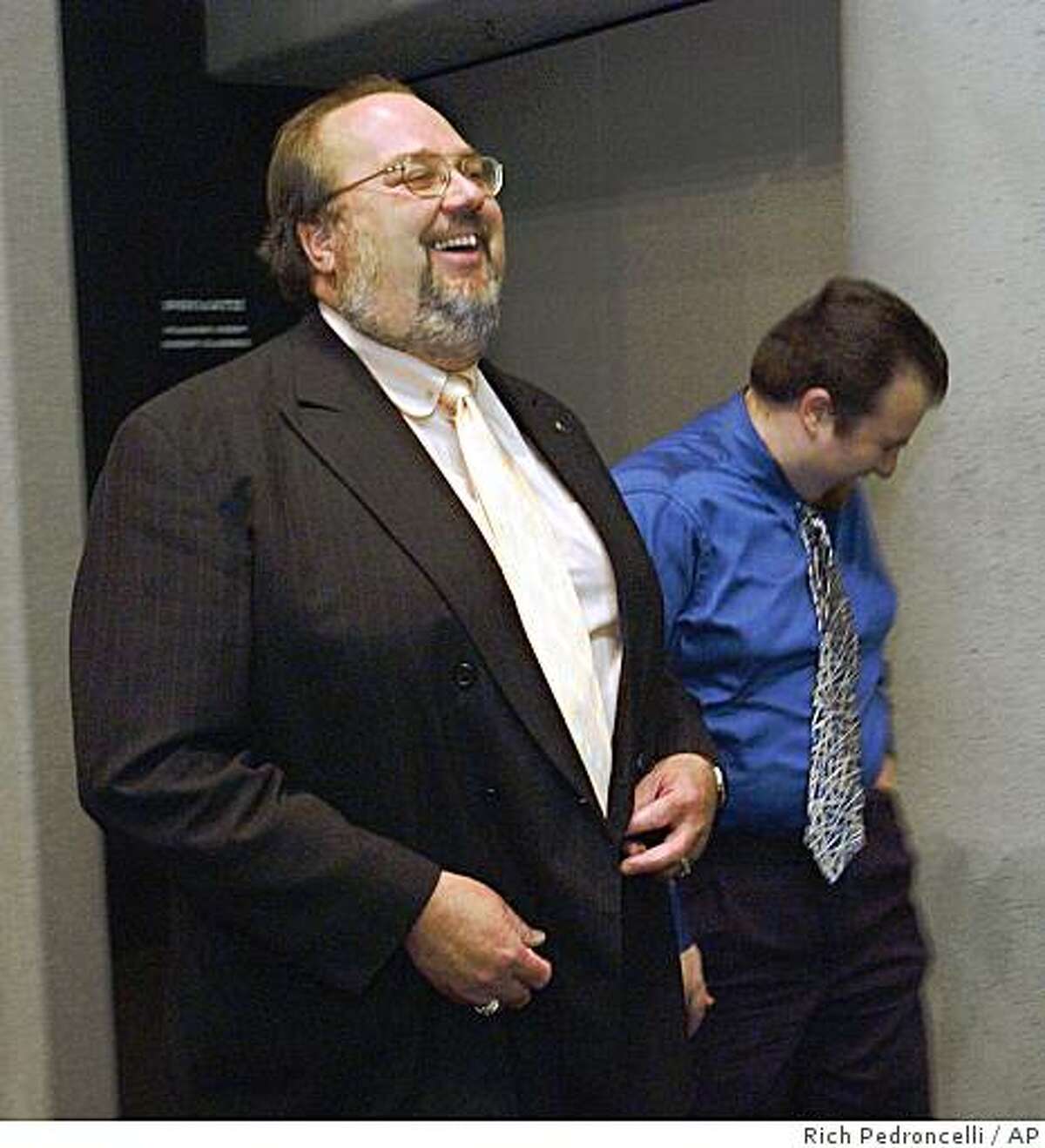 Rob Feckner, left, who was just elected California Employees Retirement System board president, laughs at a comment made by his son, Carl Baughman, right, as they leave the CalPERS board meeting in Sacramento, Calif., Wednesday Feb. 16, 2005. By a 12-0 vote Feckner, 47, a 27-year school employee and statewide union official, replaces Sean Harrigan, who was ousted in December (AP Photo/Rich Pedroncelli)