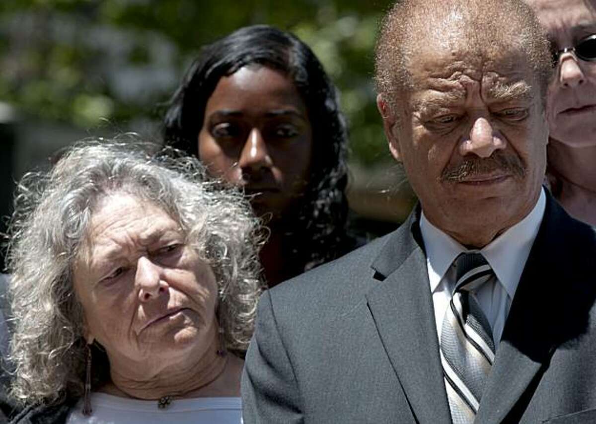 Susan Harman (left) and Walter Riley, both arrested during the protests following the Mehserle verdict, listen during a press conference held in front of Oakland City Hall on Wednesday, July 14, 2010 to discuss the actions of police as they arrested protestors following the verdict in the Mehserle case.