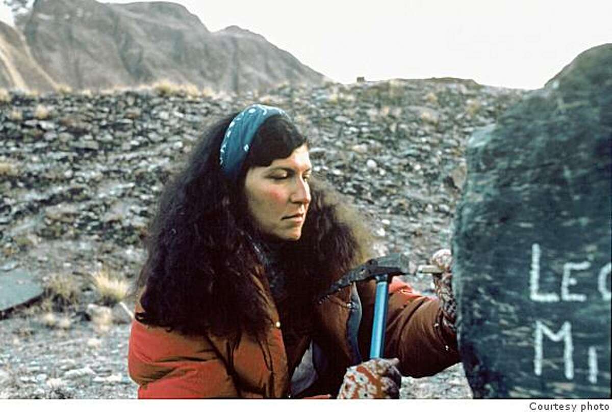 Arlene Blum soberly chisels the names of Vera Watson and Alison Chadwick-Onyszkiewicz into a boulder at base camp, two climbers who fell to their deaths during the otherwise successful campaign to put a women's team on the summit of Annapurna in 1978.