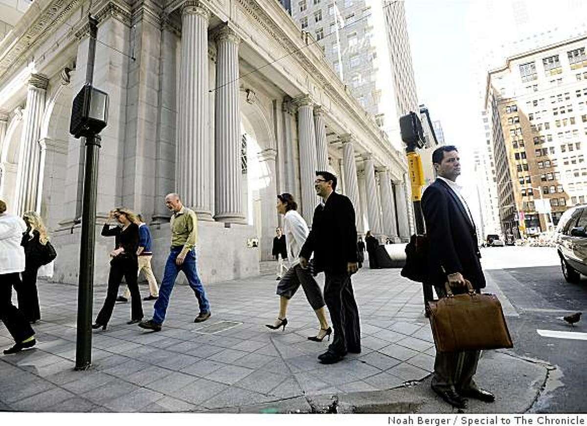 Pedestrians pass One Sansome St. in San Francisco in this file photo.