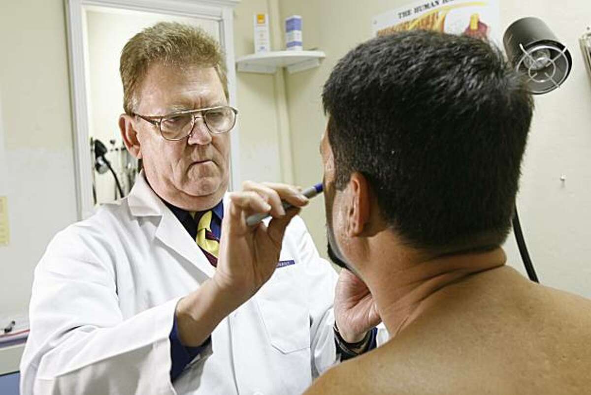 Dr. Marcus Conant performs a plastic surgery procedure at his office in San Francisco, May 4, 2006.