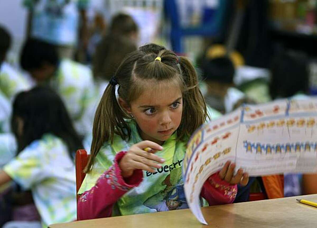 Gabby Griffin studies a worksheet in her kindergarten class at Thornhill Elementary School in Oakland, Calif., on Wednesday, June 9, 2010. If approved, a bill would restrict minimum age of enrollment in kindergarten classes to five-years-old.