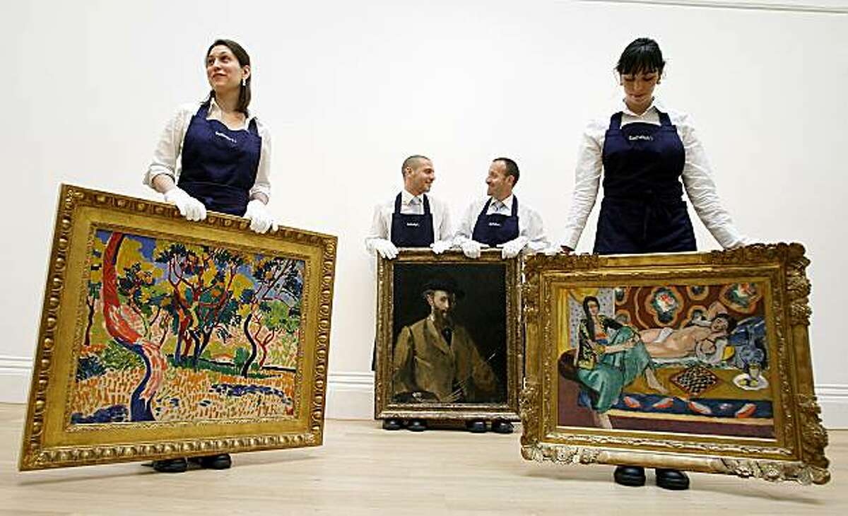 ** CORRECTS SPELLING OF ABRES A COLLIOURE ** Employees display paintings of Edouard Manet's Self Portrait with a Palette, centre, estimated at 20-30 million pounds, $29-43.4 million, Henri Matisse's Odalisques Jouant Aux Dames, which is estimated at 10-15million pounds, $14.5-21.7 million right, and Andre Derain's Arbres a Collioure, estimated to fetch 9-14 million pounds, $13-20.3 million, during a photocall at Sotheby's, in London, Friday, June, 11, 2010. These paintings will go under the hammer during the Impressionist and Modern Art sales on June 22 .