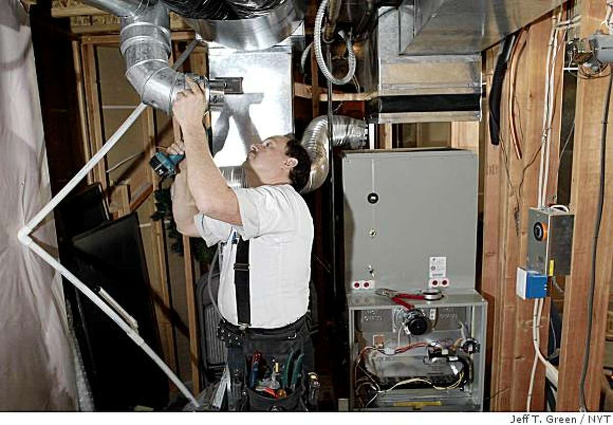 Don Honn installed fresh ductwork on Thursday, Oct. 13, 2005, for a new Trane gas furnace in Spokane, Wash., that replaced a 1991 version. With home energy bills expected to rise almost 50 percent this winter, the frugal American may face a tough call: the most effective way to cut that expense may be to spend thousands of dollars to replace an inefficient furnace. (Jeff T. Green/The New York Times)