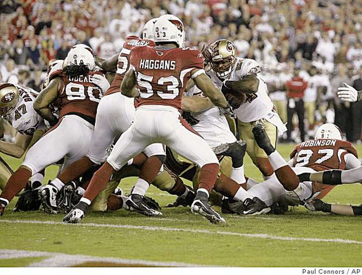 ** CORRECTS NAME OF PLAYER TO MICHAEL ROBINSON FROM FRANK GORE ** San Francisco 49ers runningback Michael Robinson , right, is stopped at the goal line by Arizona Cardinals' Clark Haggans (53) Darnell Dockett (90), and Karlos Dansby, center, during the final quarter of an NFL football game Monday, Nov. 10, 2008 in Glendale, Ariz. The Cardinals won 29-24.(AP Photo/Paul Connors)