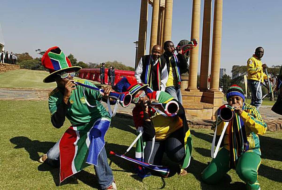 South Africa's government staffers blow horns during the ultimate Football Friday celebration at the government residence in Pretoria, Friday, June 4, 2010. During Football Fridays, that were activated last year to mobilize the country behind hosting theWorld Cup, South Africans were encouraged to wear their team's colors. The first soccer World Cup to be played in Africa kicks-off on June 11.