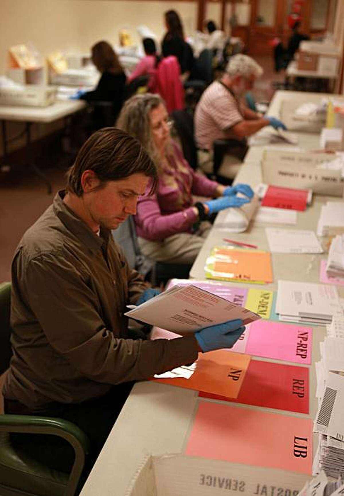 Vote by mail ballots being manually sorted by Daniel Libby at the department of elections ballot distribution staff today at City Hall in San Francisco, Calif., on Monday, June 7, 2010.