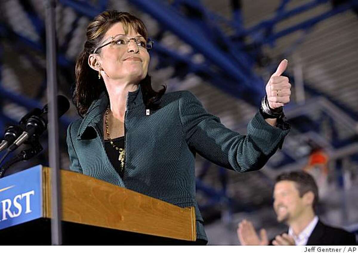 Republican vice presidential candidate, Alaska Gov. Sarah Palin, left, along with her husband Todd Palin attend a rally at Marietta Collage Sunday, Nov. 2, 2008 in Marietta, Ohio. (AP Photo/Jeff Gentner)