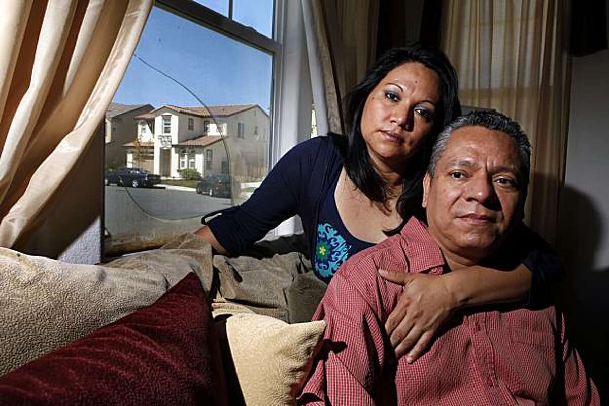 Jose and Lucy Vega sit in their foreclosed living room of their Pittsburg home. Jose was on the phone talking with his lender, Chase Bank, about his loan modification when a real estate agent knocked on the door and told him his house had already been foreclosed on.