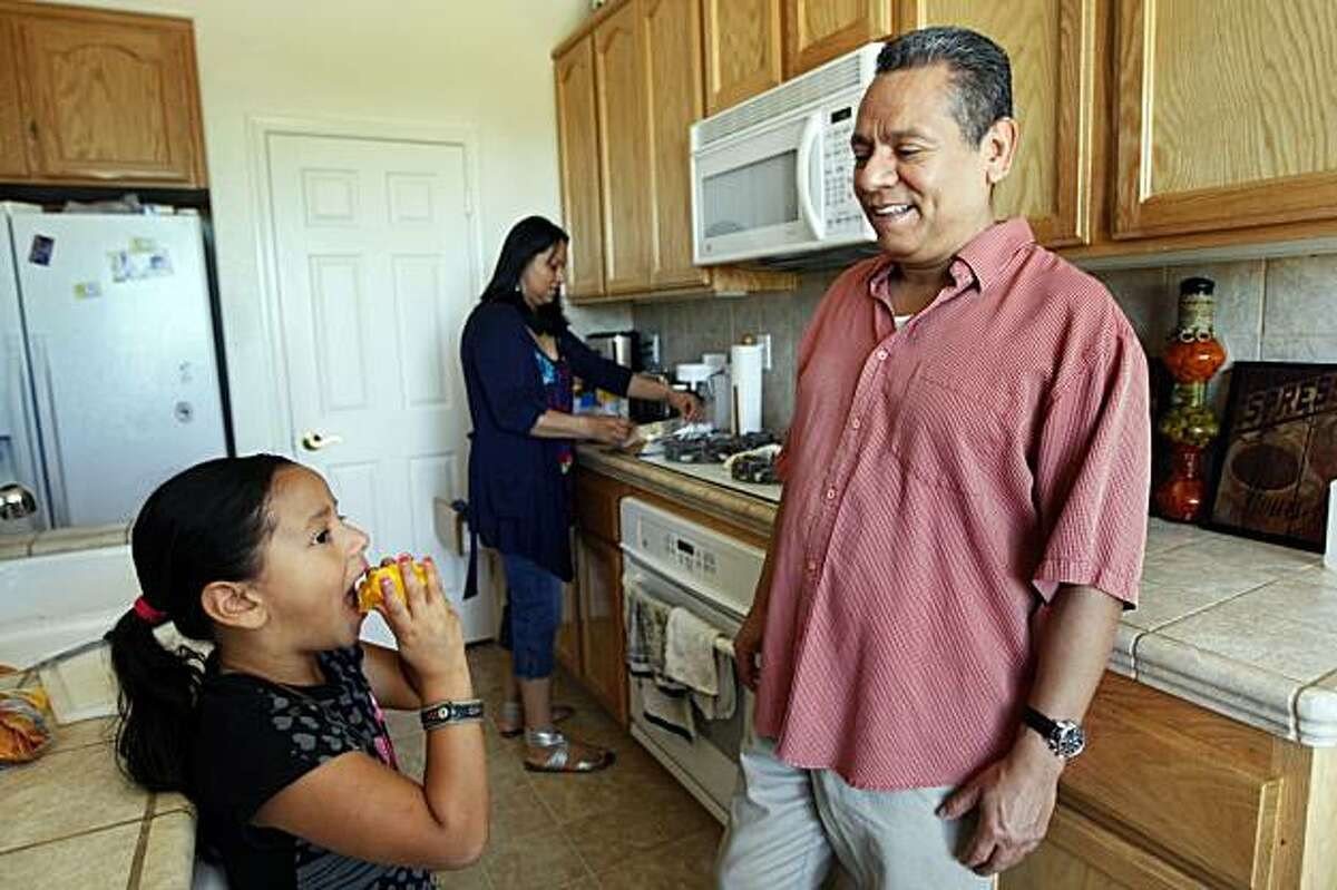 Jose and Lucy Vega prepare fruit snacks for their daughter Luciana age 5 in their foreclosed Pittsburg home Saturday May 29, 2010. Jose was on the phone talking with his lender, Chase Bank about his loan modification when a real estate agent knocked on the door and told him his house had already been foreclosed on. A proposed California bill seeks to prevent such situations by requiring lenders to give a decision on loan mods before starting foreclosure proceedings.