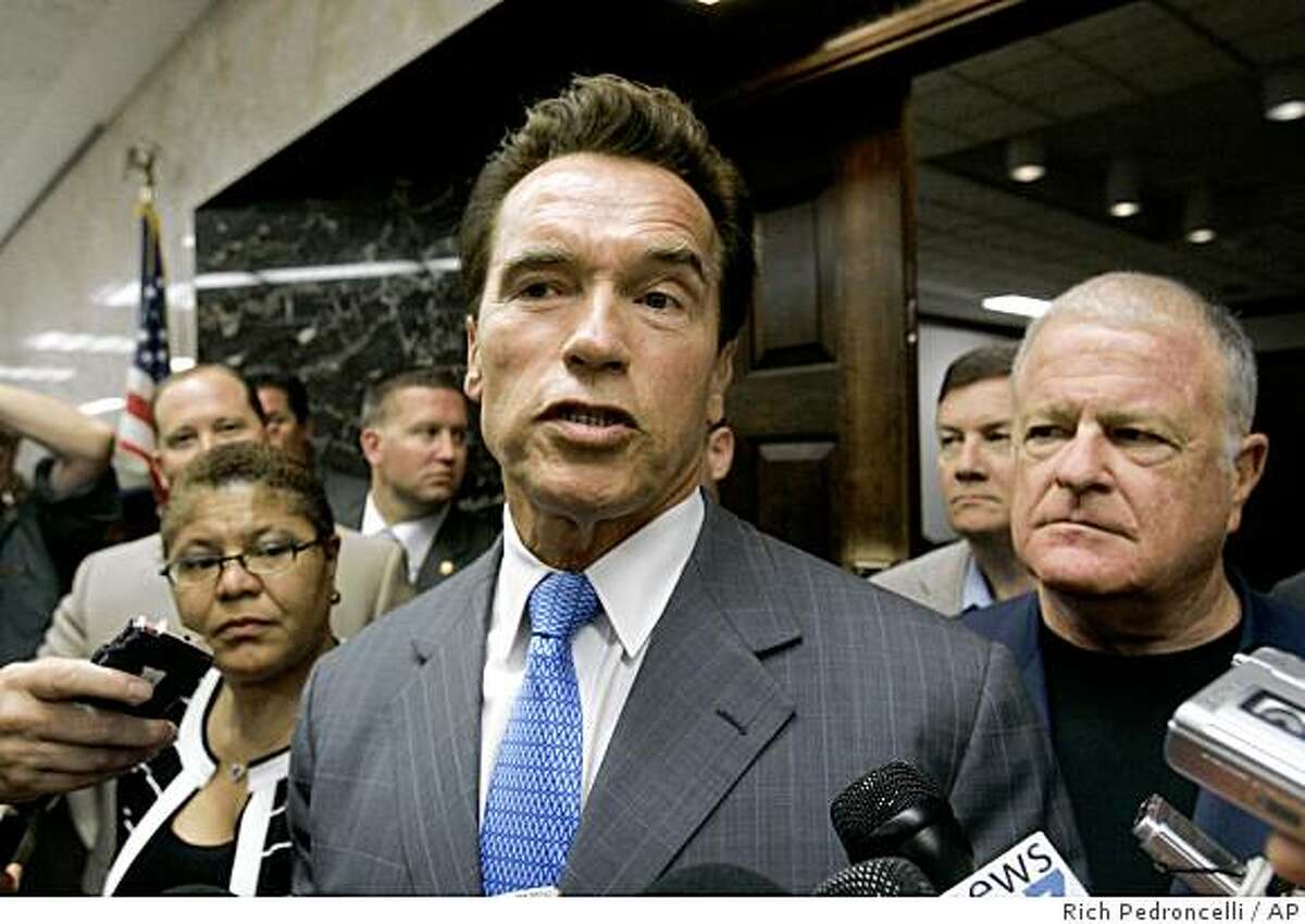 Gov. Arnold Schwarzenegger announces that he would call the Legislature into a special session to deal with the looming state budget crisis, outside his Capitol office in Sacramento, Calif., Monday, Oct. 27, 2008. Schwarzenegger, flanked by Assembly Speaker Karen Bass, of Los Angeles, left, Senate Minority Leader Dave Cogdill, of Modesto, second from right, and state Senate President Pro Tem Don Perata, of Oakland, right, said he would call lawmakers in for a special session immediately after the Nov. 4 elections.(AP Photo/Rich Pedroncelli)