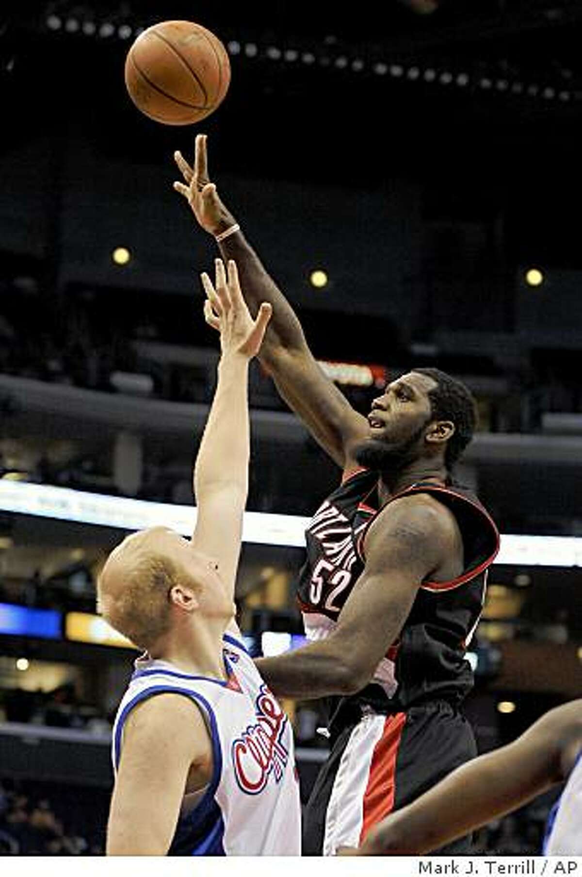 Blazers center Greg Oden puts up a shot as Los Angeles Clippers center Chris Kaman defends during the first half on Wednesday, Oct. 22, 2008, in Los Angeles.