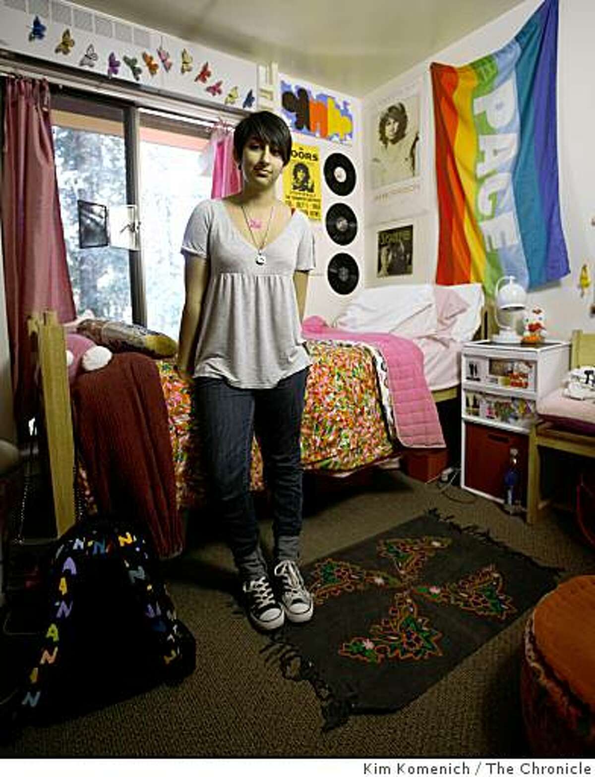 Saachi Dhingra, stands in her dorm room at UC Santa Cruz in Santa Cruz, Calif. Her parents thought they had saved enough money for four years of private or public college and at least a part of medical school. Now the market has shrunk that fund so much that she will have to rely on aid for the last year at the public UC Santa Cruz and is on her own for graduate school.