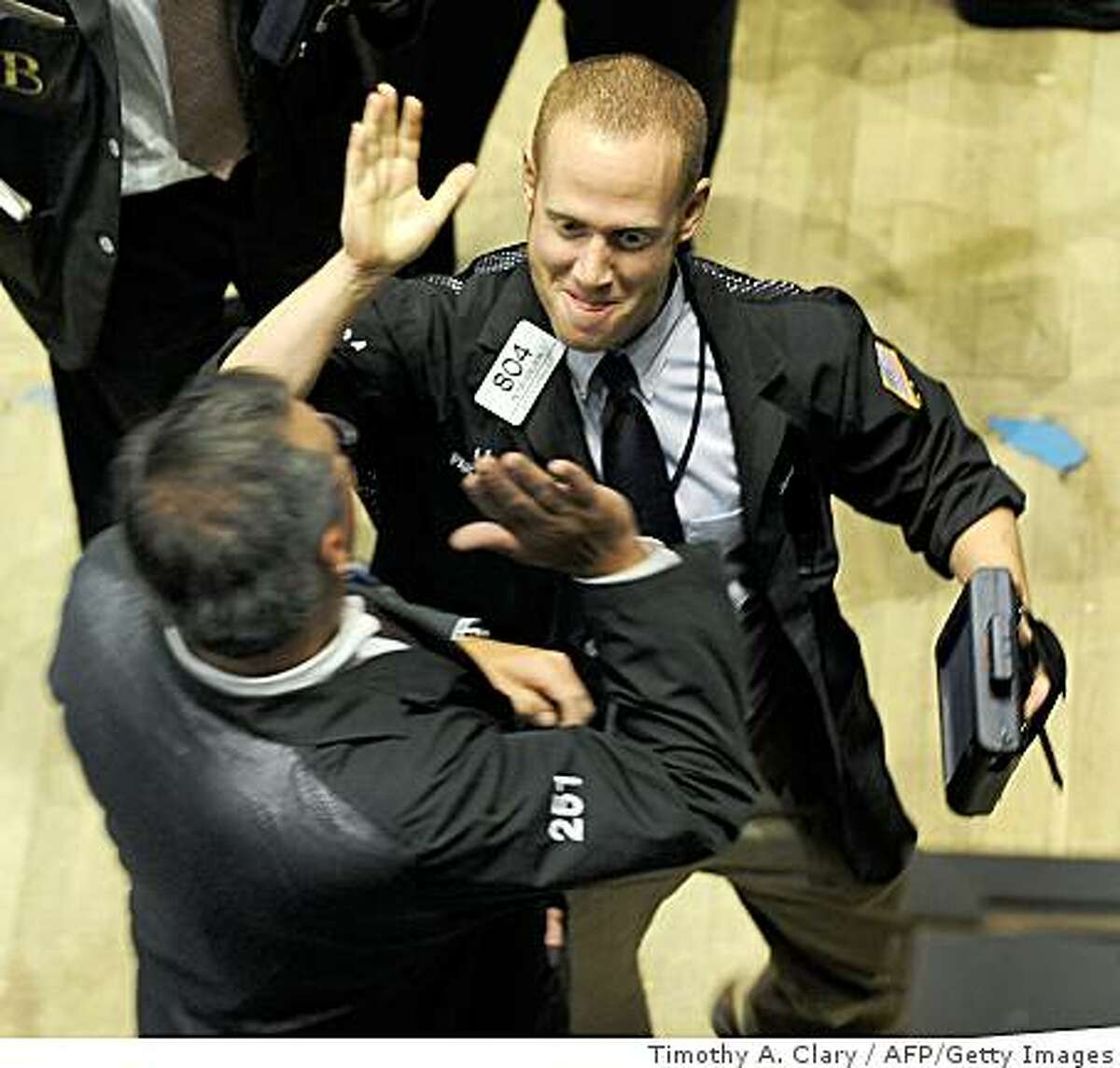 Traders celebrate on the floor of the New York Stock exchange on October 13, 2008 in New York City at the closing bell. U.S. stocks surged more than 11 percent, with the Dow index registering its biggest point gain ever as investors cheered governments' action plans to combat the global financial crisis.