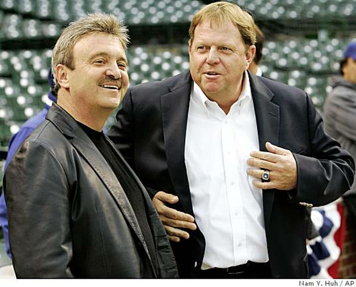 Los Angeles Dodgers general manager Ned Colletti, left, talks to the Chicago Cubs general manager Jim Hendry during baseball practice, Tuesday, Sept. 30, 2008 in Chicago. The Dodgers take on the Chicago Cubs in Game 1 of the National League division series on Wednesday. (AP Photo/Nam Y. Huh)