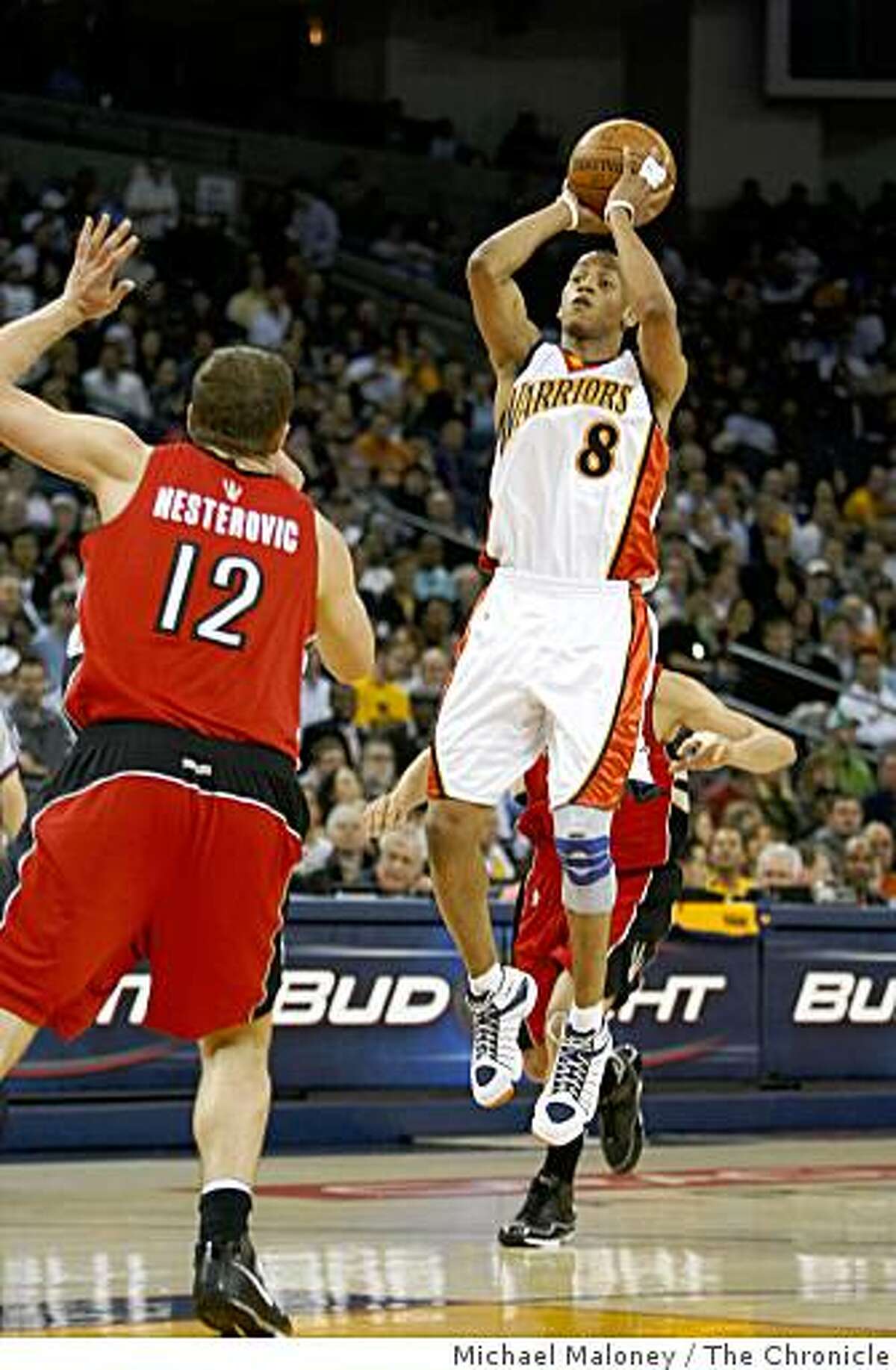 Golden State Warriors Monta Ellis (8) goes up for a basket against Toronto Raptors Rasho Nesterovic (12) in the 1st half.The Golden State Warriors host the Toronto Raptors in a NBA game at Oracle Arena in Oakland, Calif., on March 12, 2008.Photo by Michael Maloney / San Francisco Chronicle