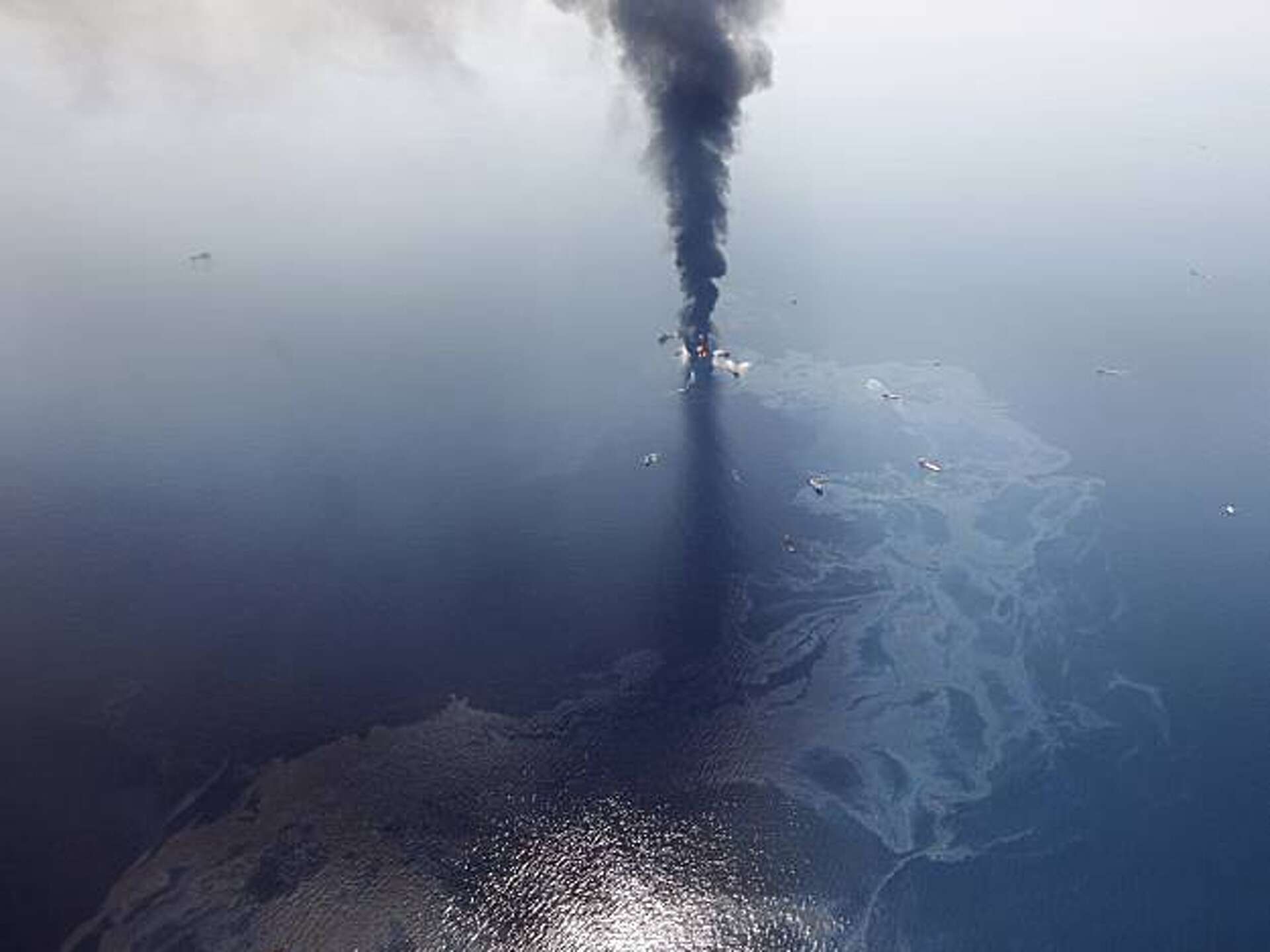 Burning oil rig sinks - major spill feared