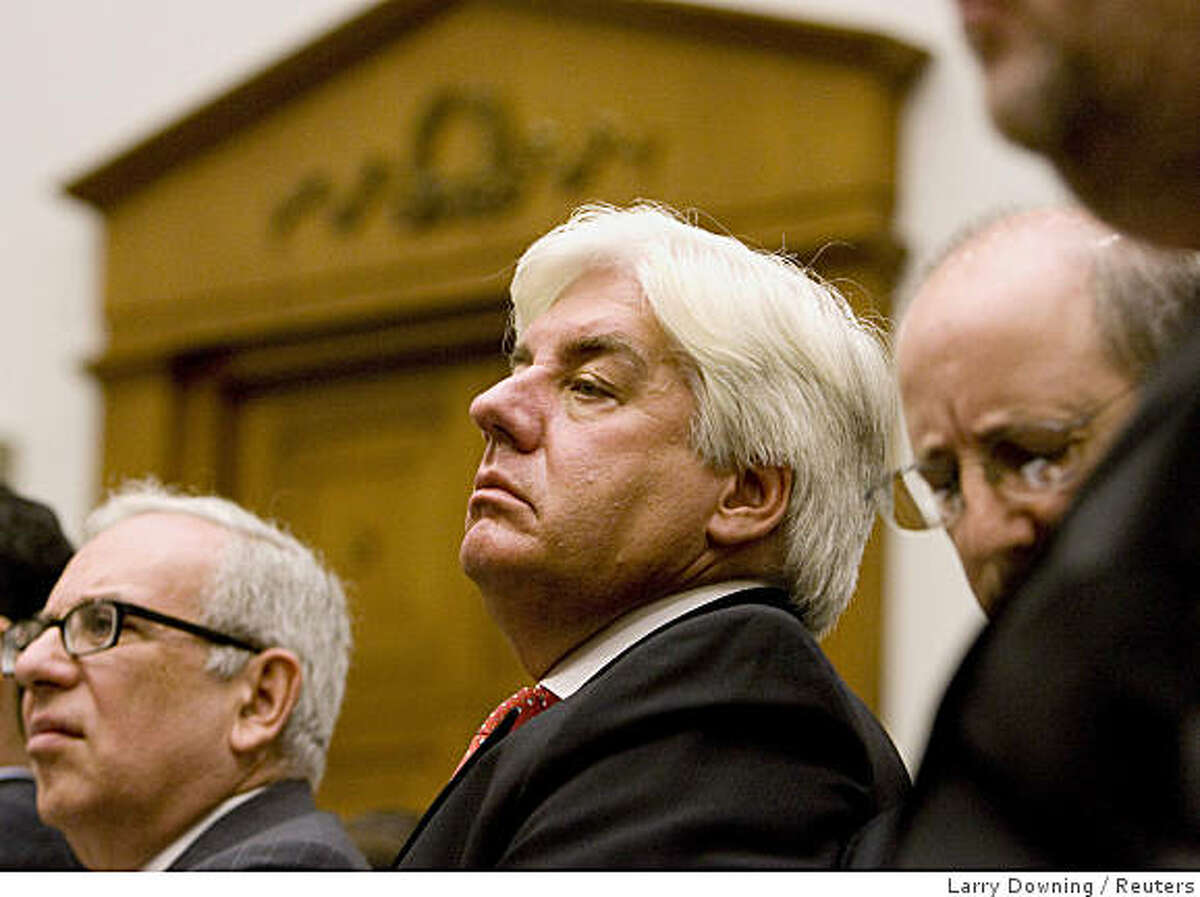 Former AIG CEO Martin Sullivan (center) listens at the U.S. House Oversight and Government Reform Committee hearing on the cause and effects of the AIG bailout on Capitol Hill on Tuesday.