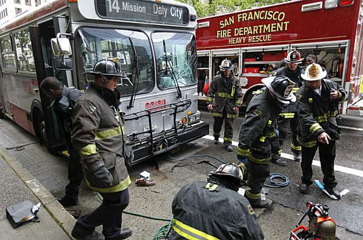 San Francisco Fire personnel investigate the scene where a MUNI bus collided with a pedestrian in the East bound lanes of Mission Street just East of Beale Street in the financial district of San Francisco, Calif. on Wednesday Apr. 21, 2010.