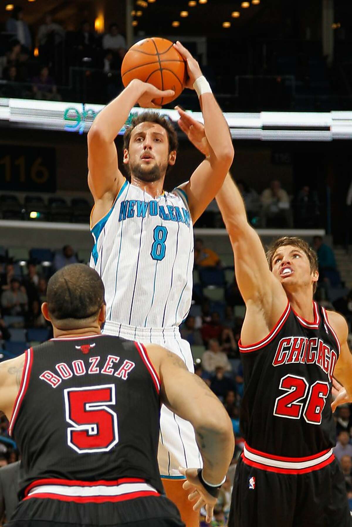 NEW ORLEANS, LA - FEBRUARY 08: Marco Belinelli #8 of the New Orleans Hornets shoots the ball over Kyle Korver #26 and Carlos Boozer #5 of the Chicago Bulls at New Orleans Arena on February 8, 2012 in New Orleans, Louisiana. NOTE TO USER: User expressly acknowledges and agrees that, by downloading and or using this photograph, User is consenting to the terms and conditions of the Getty Images License Agreement. (Photo by Chris Graythen/Getty Images)
