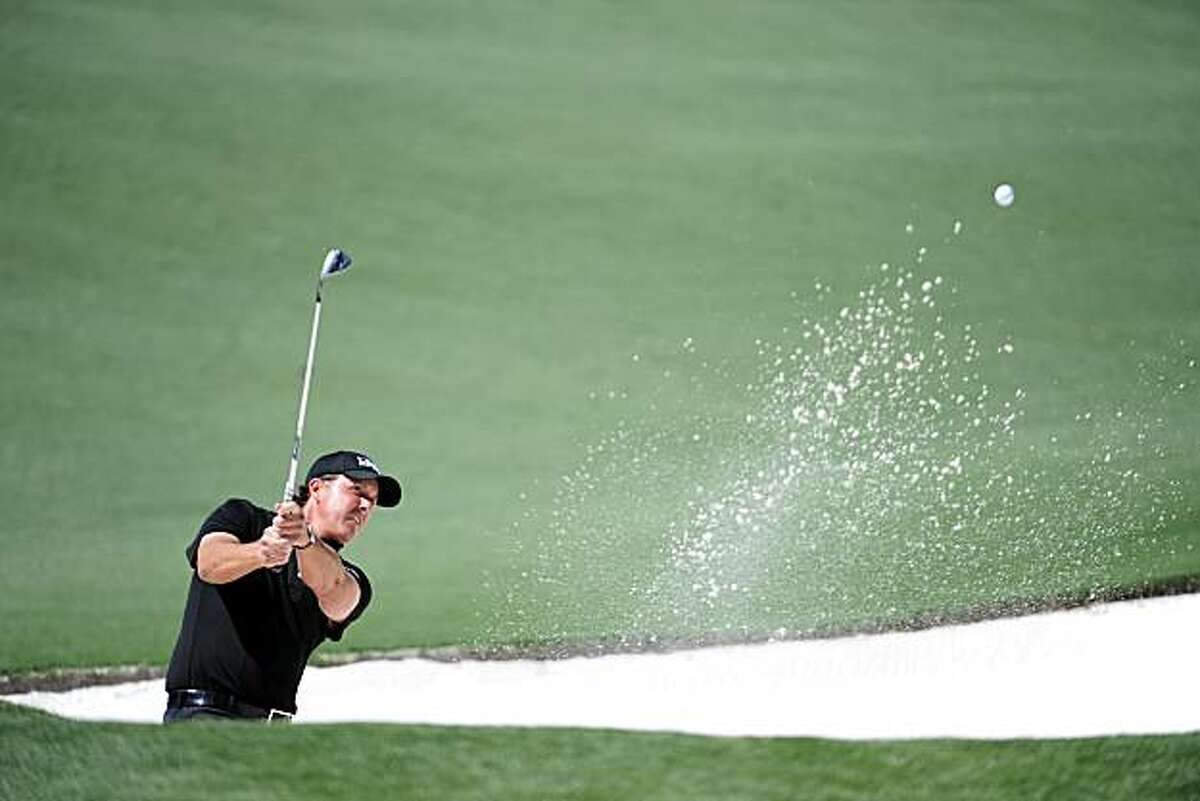 AUGUSTA, GA - APRIL 11: Phil Mickelson plays a bunker shot on the second hole during the final round of the 2010 Masters Tournament at Augusta National Golf Club on April 11, 2010 in Augusta, Georgia.