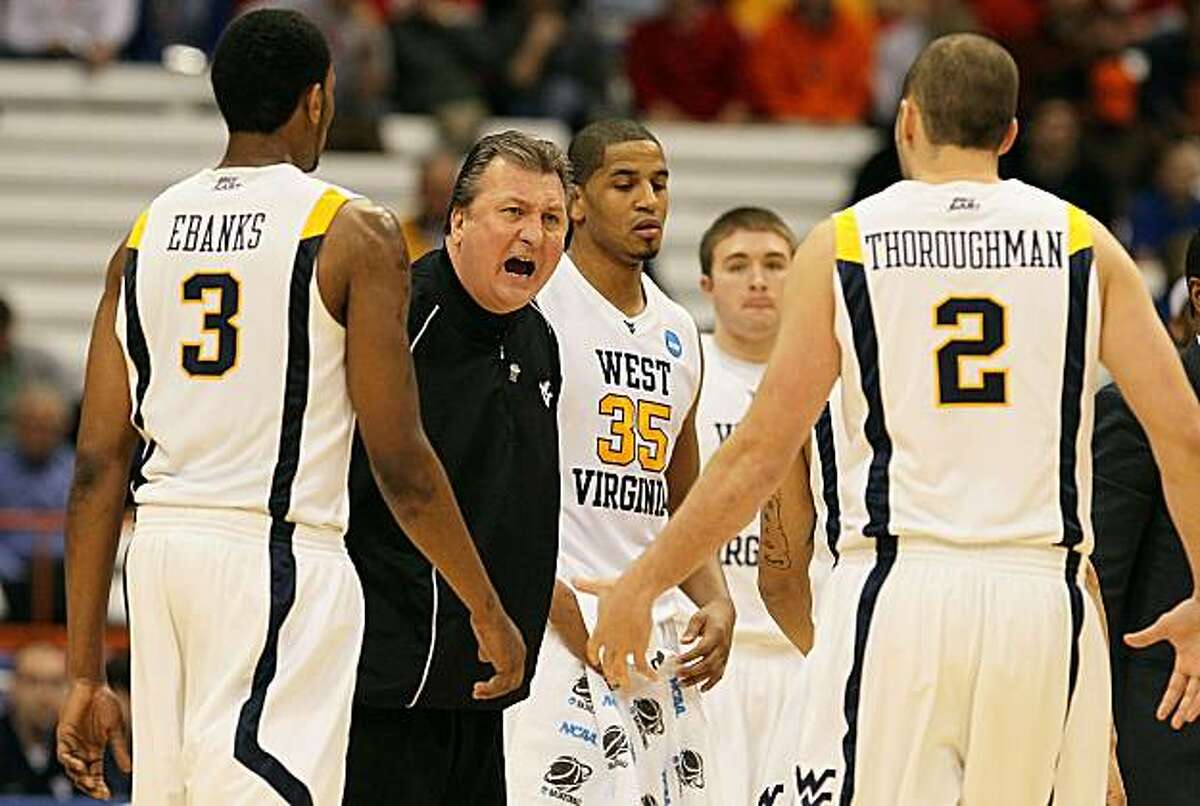 SYRACUSE, NY - MARCH 25: Head coach Bob Huggins of the West Virginia Mountaineers reacts as he addresses his players during a timeout in the first half against the Washington Huskies during the east regional semifinal of the 2010 NCAA men's basketball tournament at the Carrier Dome on March 25, 2010 in Syracuse, New York.