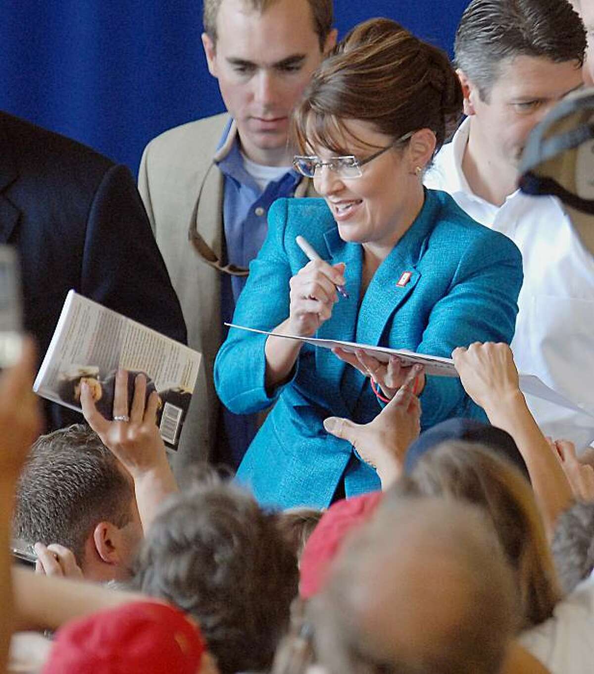Republican vice presidential candidate, Alaska Gov. Sarah Palin, signs autographs, Friday, Sept. 19,2008, during a rally at the Anoka County Airport in Blaine, Minn. (AP Photo/Janet Hostetter)