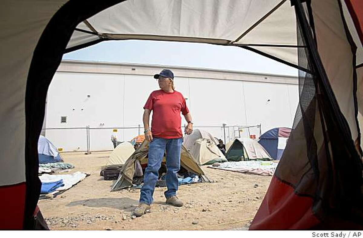 Sylvia Flynn, 51, stands outside her tent at the tent city that sprung up next to the homeless shelter in downtown Reno, Nev., Wednesday, June 25, 2008. Flynn has been homeless off and on for nearly 31 years she said. (AP Photo/Scott Sady)