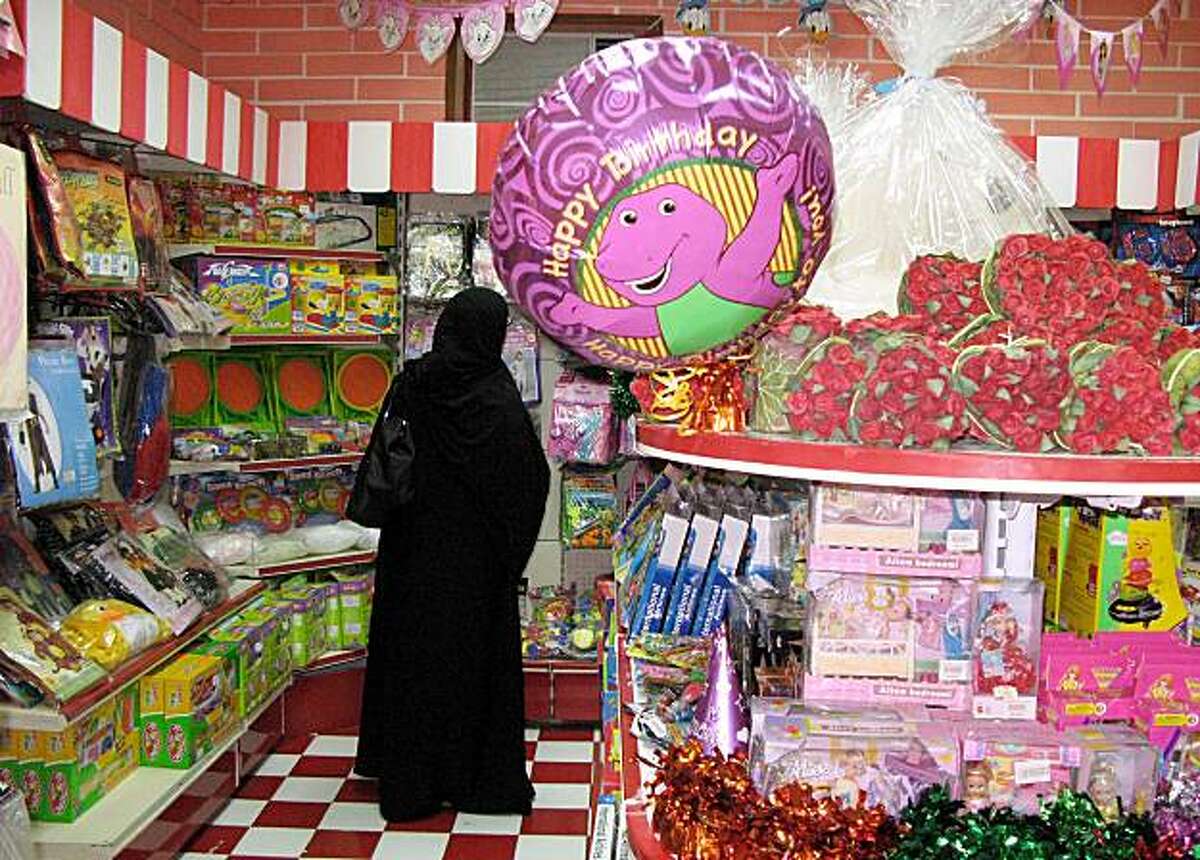 A woman looks for a birthday item at a gift shop in Riyadh, Saudi Arabia, Wednesday Sept. 3, 2008. The mixed attitude in Saudi Arabia toward birthdays was reflected recently in an unusual public controversy over the issue, with one prominent cleric saying there's nothing un-Islamic about them and another, Sheik Abdul-Aziz Al Sheik, the kingdom's grand mufti and top religious authority, strongly opposing them. (AP Photo/Hassan Ammar)