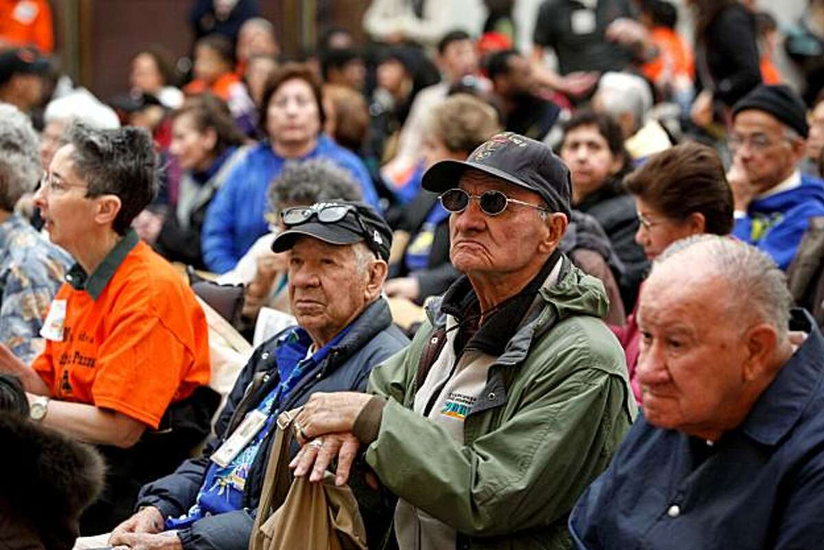 Miguel Rangel, a 46-year Muni rider, listens to public comments during a public meeting of the San Francisco Municipal Transportation Agency in San Francisco on Friday. The agency is facing a $16.9 million budget deficit. Rangel joined about two hundred others in the South Light court of City Hall who were unable to get inside the meeting.