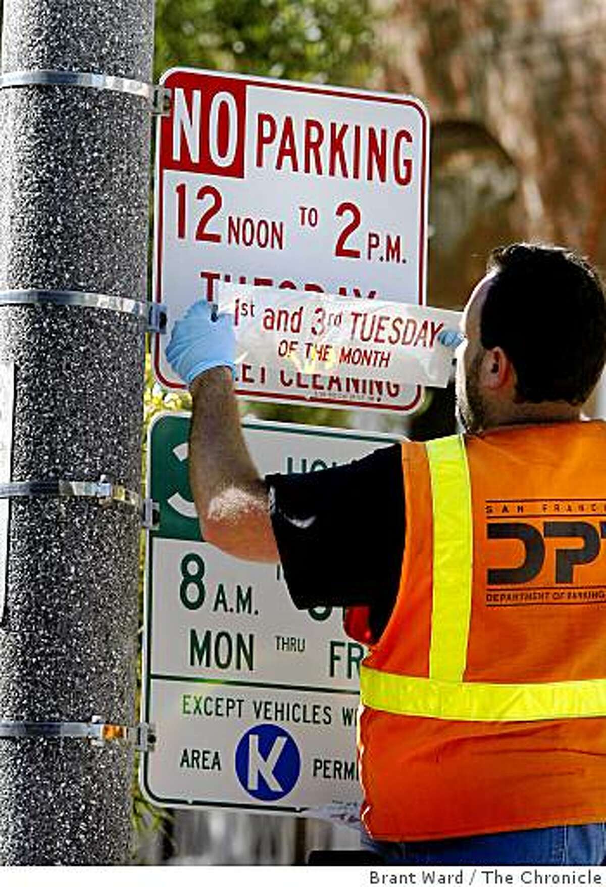 Mike Turner of Dept. of Parking and Traffic changed street sweeping signs Monday August 25, 2008 along Filbert Street near Divisadero.Residents of San Francisco's Marina district who park on the street will get a break as the city scales back weekly street sweeping in many residential neighborhoods.