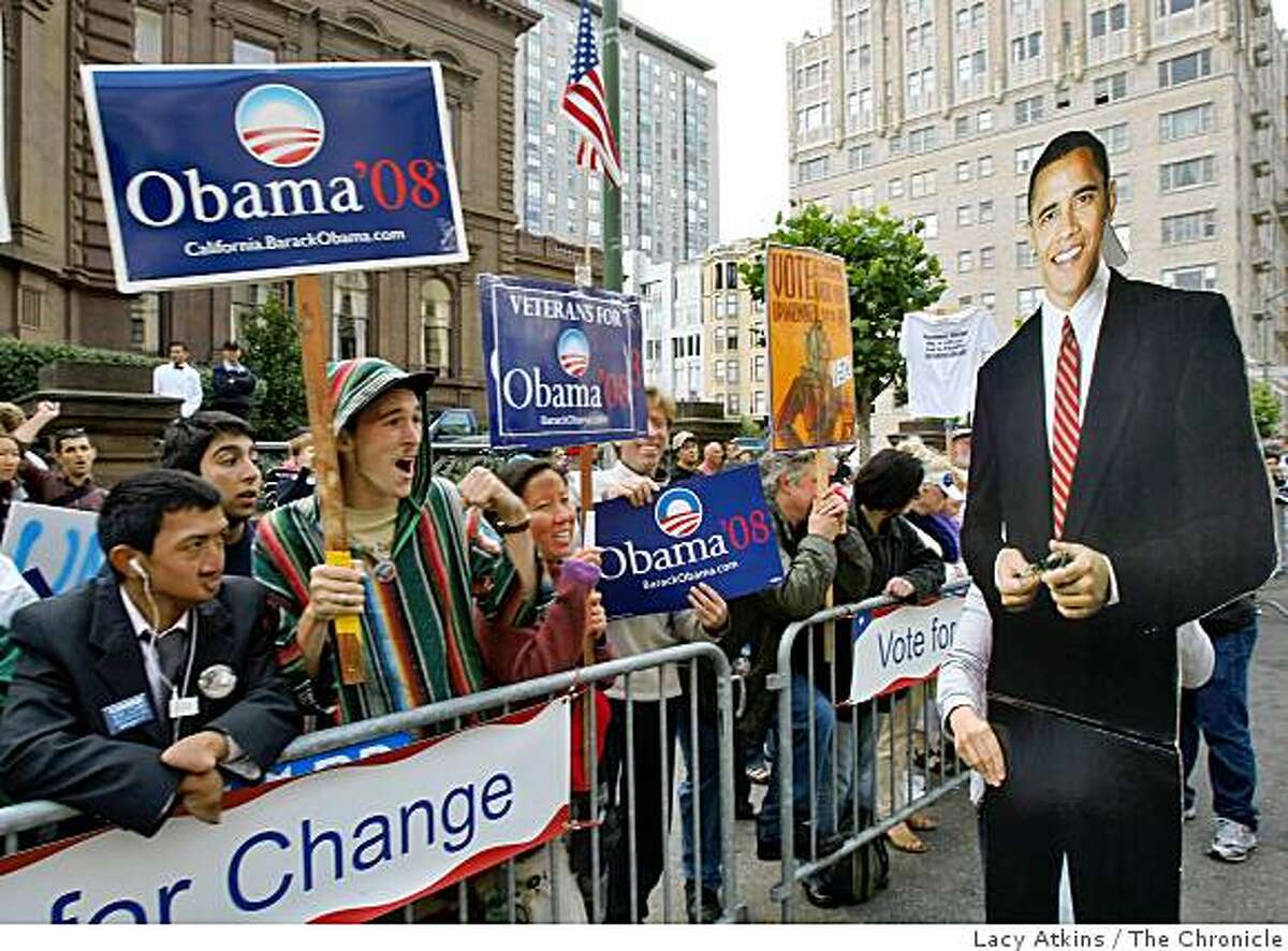 Supporters cheer as a cut out of Democratic President candidate Barack Obama is carried by Ame Szasz in front of the Fairmont Hotel where Obama is attending a fundrasier, Sunday Aug. 17, 2008, in San Francisco, Calif.