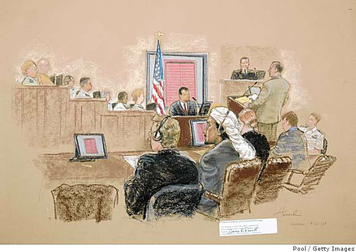GUANTANAMO BAY NAVAL BASE, CUBA - JULY 23: In this photograph of a courtroom sketch, reviewed by the U.S. Military, defendant Salim Hamdan (2nd L), sits with his defense team and reviews an exhibit displayed on a video screen during testimony on day three of his trial inside the war crimes courthouse at Camp Justice, the legal complex of the U.S. Military Commissions on July 23, 2008 in Guantanamo Bay U.S. Naval Base, in Cuba. Hamdan, the former driver for Osama bin Laden, is the first prisoner to face a U.S. war-crimes trial since World War II and is charged with conspiracy and aiding terrorism. (Photo by Janet Hamlin-Pool/Getty Images)