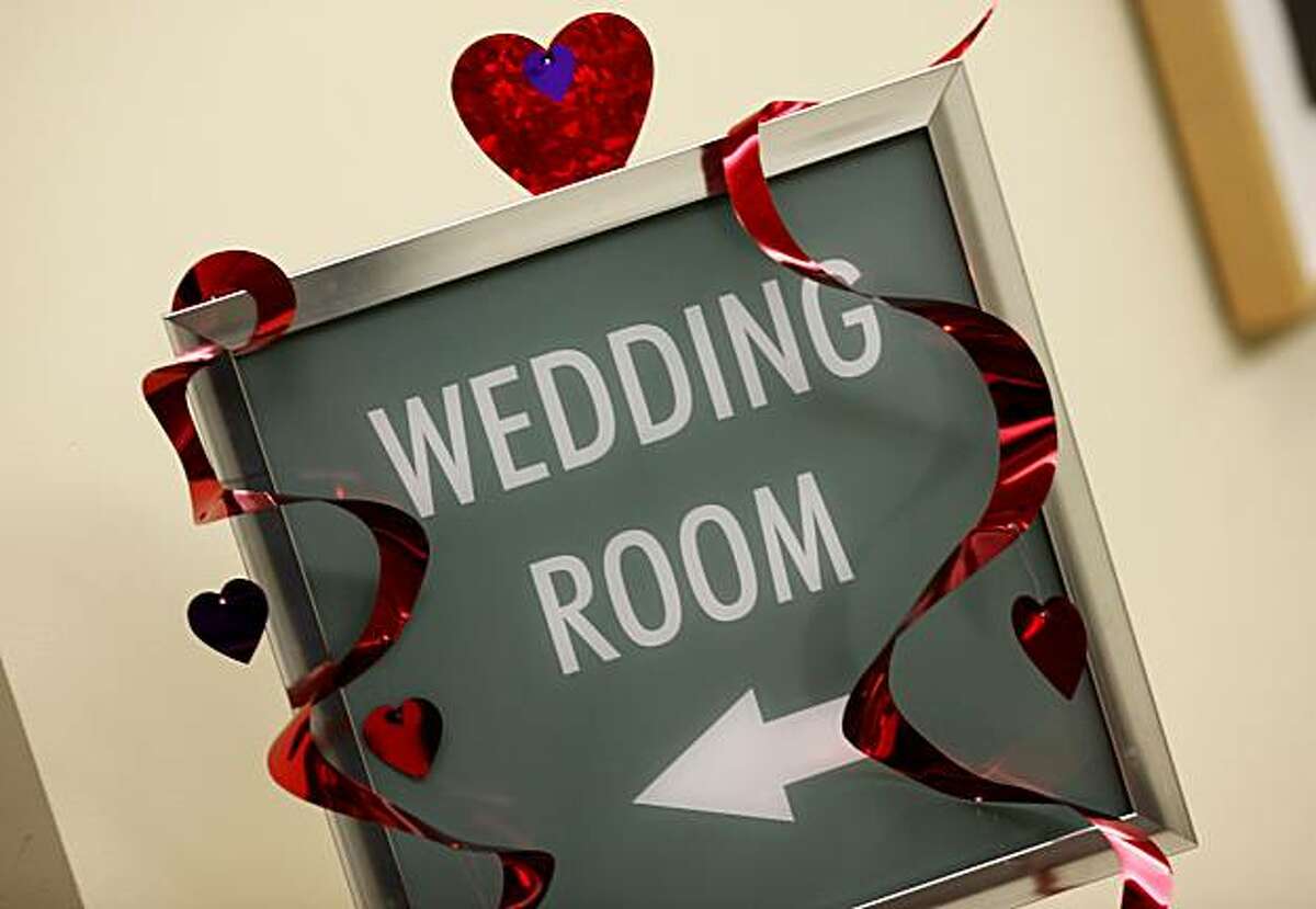 A sign on the second floor directs couples to the wedding room at the Alameda County clerk recorders offices in downtown Oakland on Valentines Day.