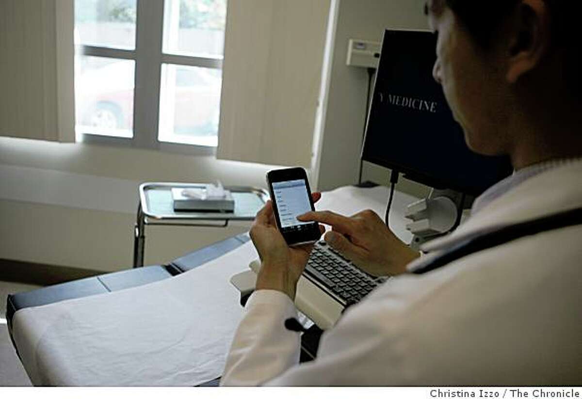 Dr. Steven Chang uses his the iPhone to access the application ePocrates in an exam room to receive updated drug information on August 5, 2008, Sacramento, Calif.Dr. Steven Chang, resident in primary care at UC Davis Medical Center, is responsible for ePocrates being on Apple's iPhone list of applications. This application allows doctors to get updated information on drugs on Tuesday, August 5, 2008, Sacramento, Calif. Photo by Christina Izzo / The Chronicle